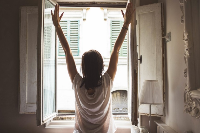 image of a woman with arms raised excitedly because she received some work productivity tips