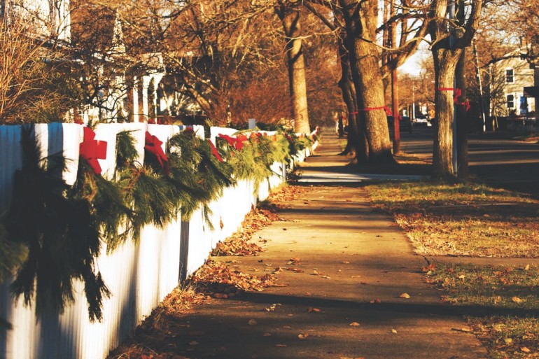 Giving back weekly series sidewalk with evergreen boughs image