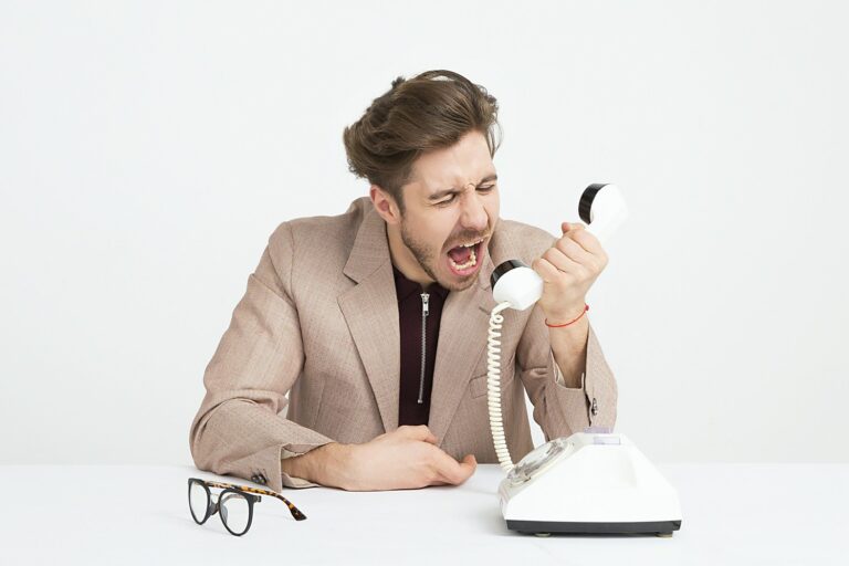 image of a man yelling into a phone symbolizing how difficult it can be when dealing with upset customers