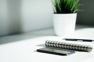 Virtual Answering Services on a cell phone at a white table