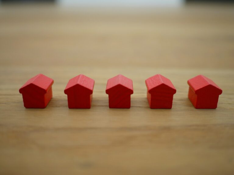 image of small red houses symbolizing the sales of real estate agents who use virtual office receptionists